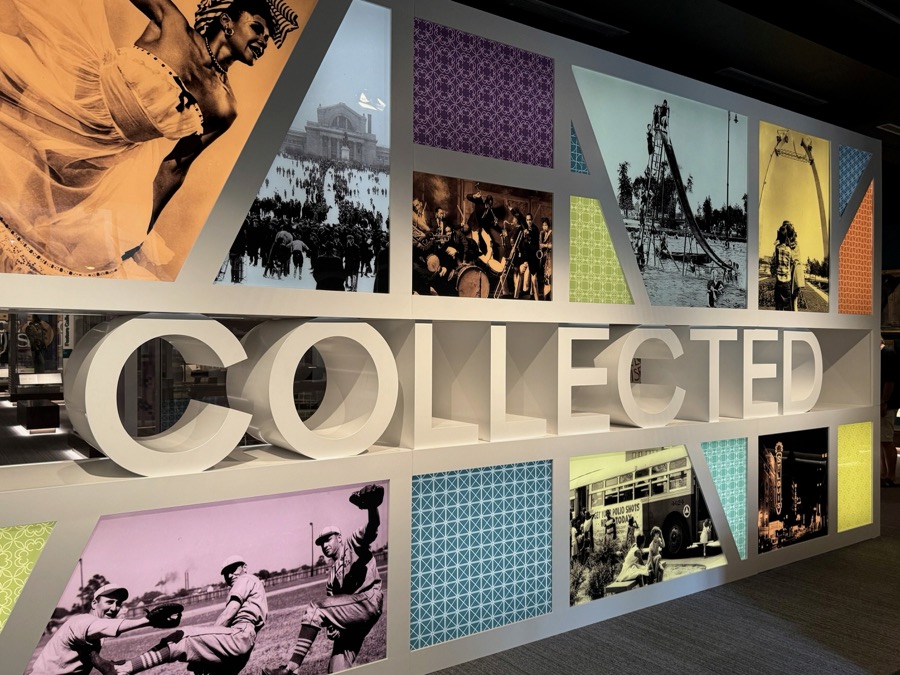 A museum wall of colorful photo panels spelling COLLECTED