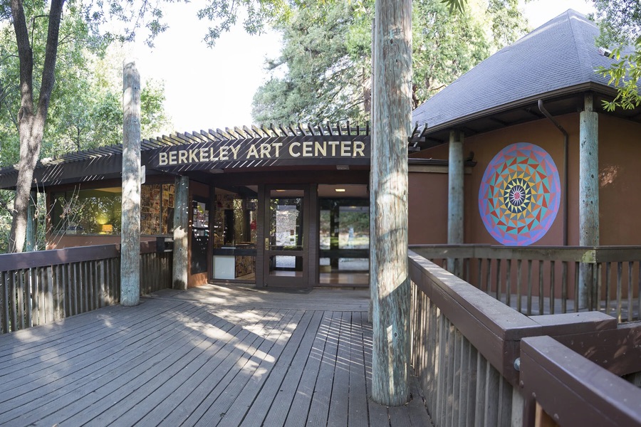 The wooden entrance of the Berkeley Art Center among trees