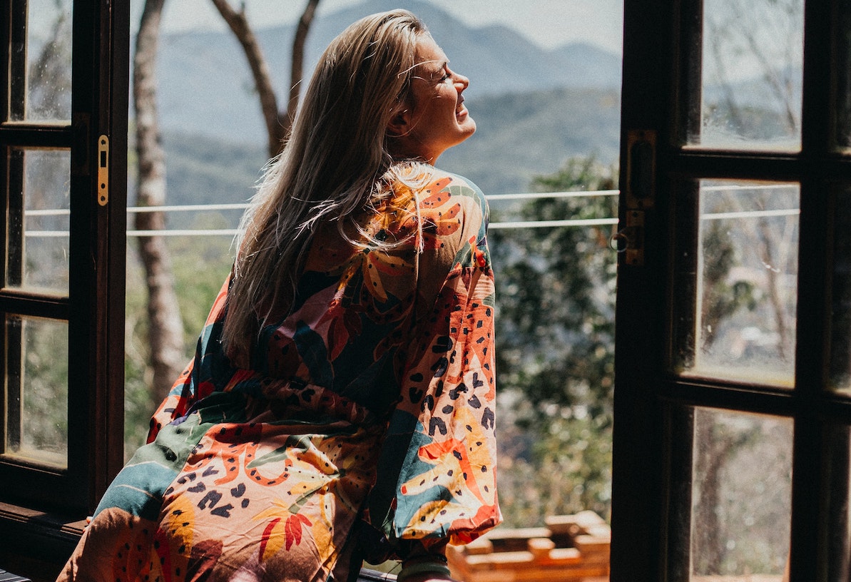 a happy woman looking out of the window