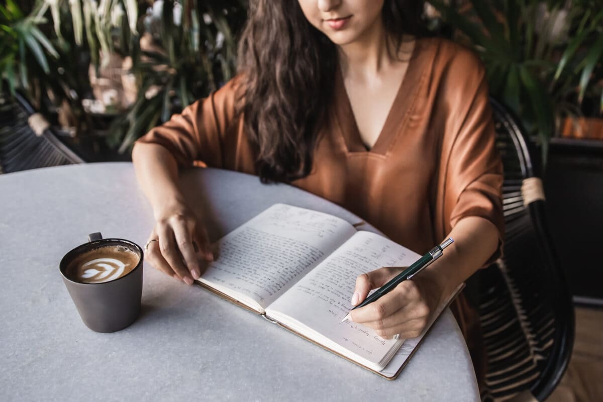 Ana Juma writing in her gratitude journal