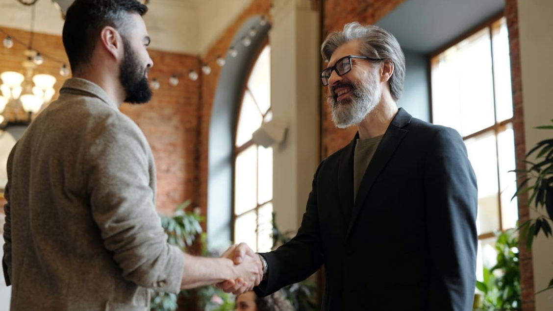 Men shaking hands in their conflict management style