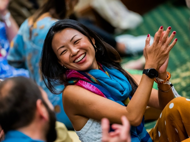 Participant of Mindvalley's A-Fest laughing with gratitude and joy