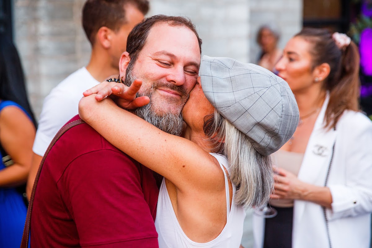 Participants of Mindvalley's A-Fest embracing in a hug of gratitude