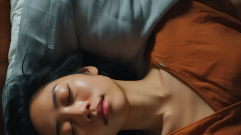 A woman resting in bed with eyes closed