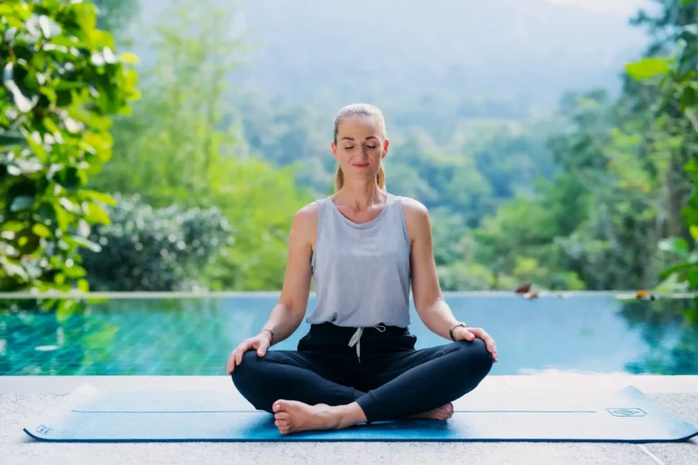 Jelena Lakic meditates by the pool in the jungle