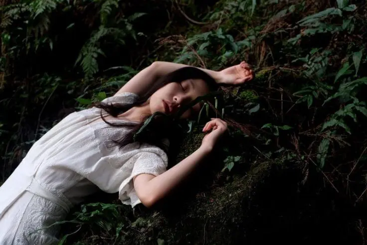 Woman using lucid dreaming helpers