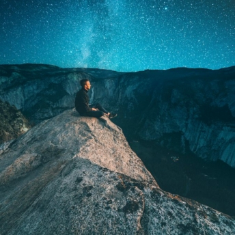 Man sitting on top of a hill as an ascended master