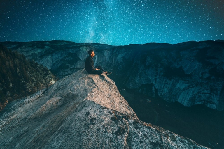 Man sitting on top of a hill as an ascended master