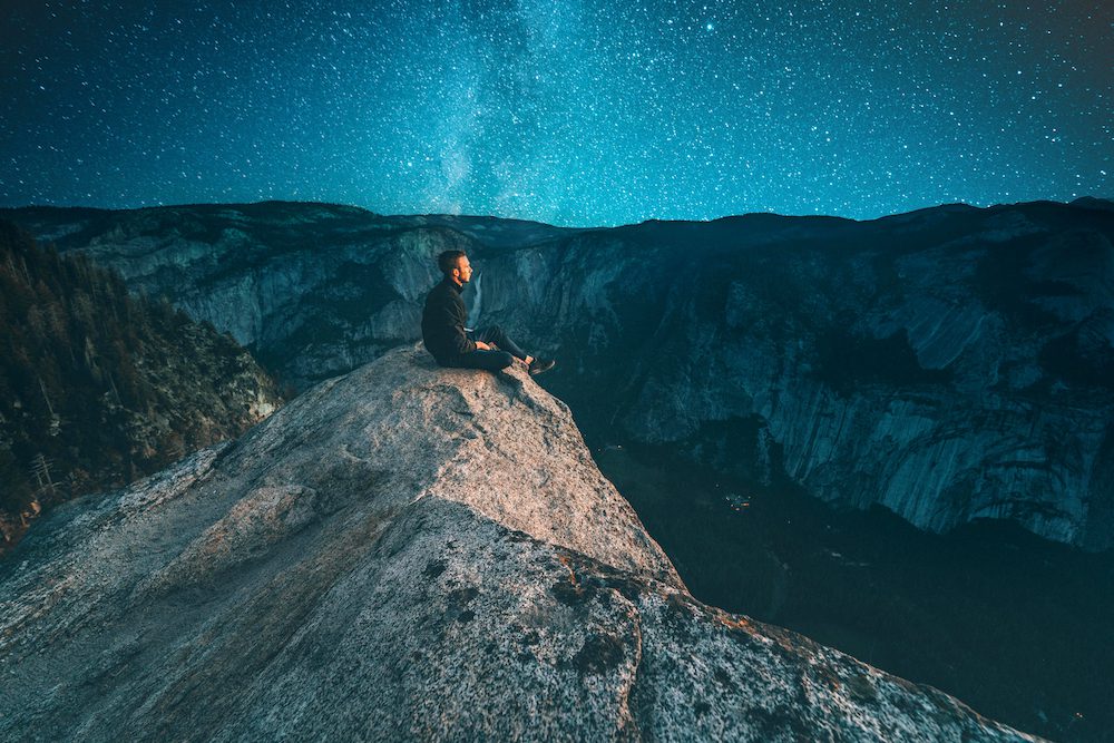 Man sitting on top of a hill as an ascended master