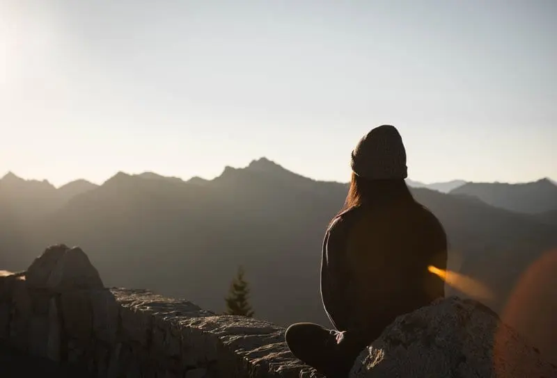 woman meditating on the mountain