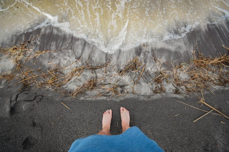 Feet by the edge of the water