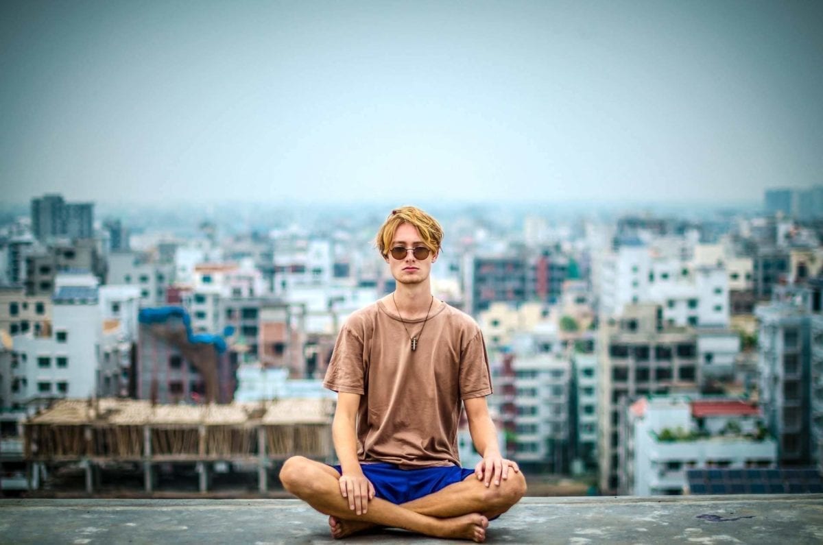 Man meditating in the city