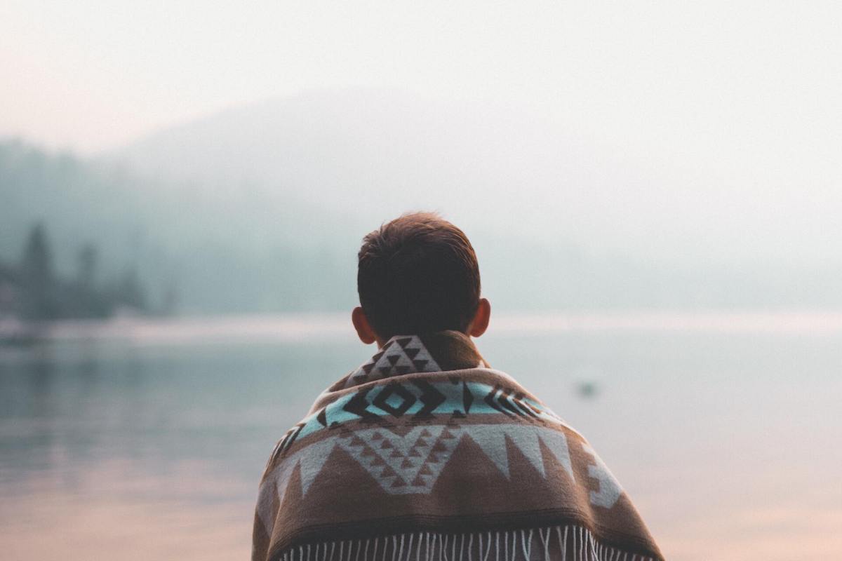 Man looking towards a lake and learning how to deal with rejection.