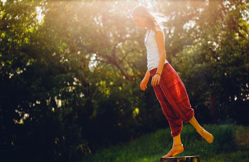 a woman standing barefoot in nature