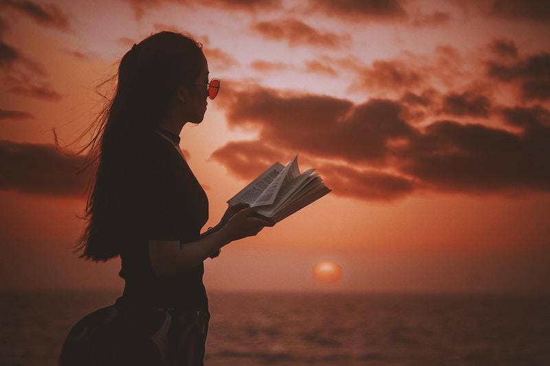 a young woman reading a book