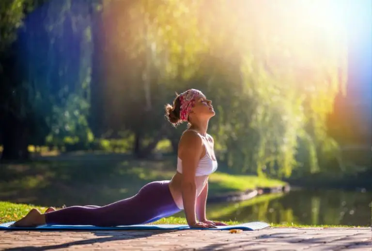 a woman doing yoga in nature