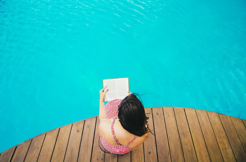 Woman reading in the pool