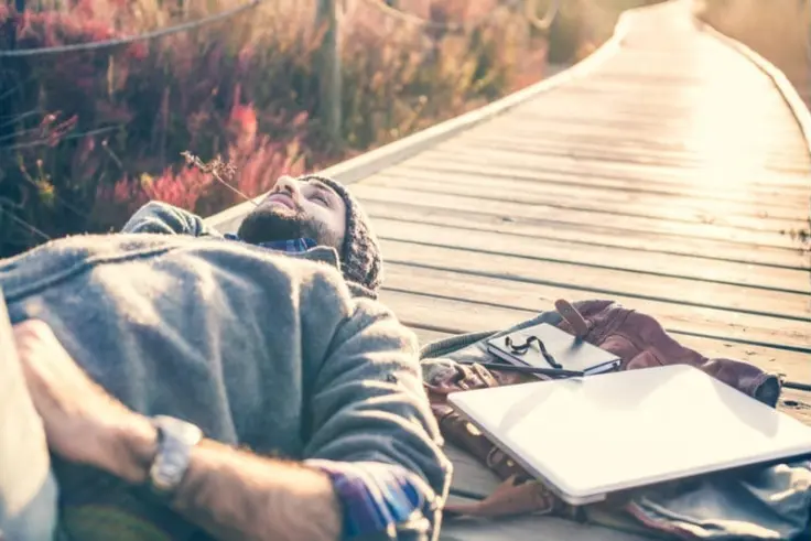 Man lying on the ground contemplating the unconscious vs subconscious mind