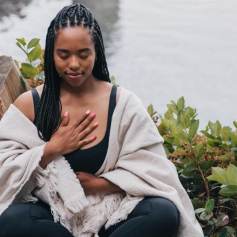 Woman with hands on her chest and stomach to display the instinct definition