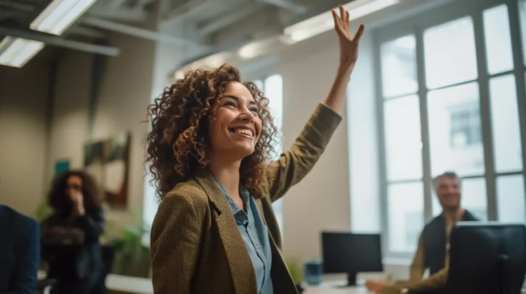 A woman raising her hand in the office