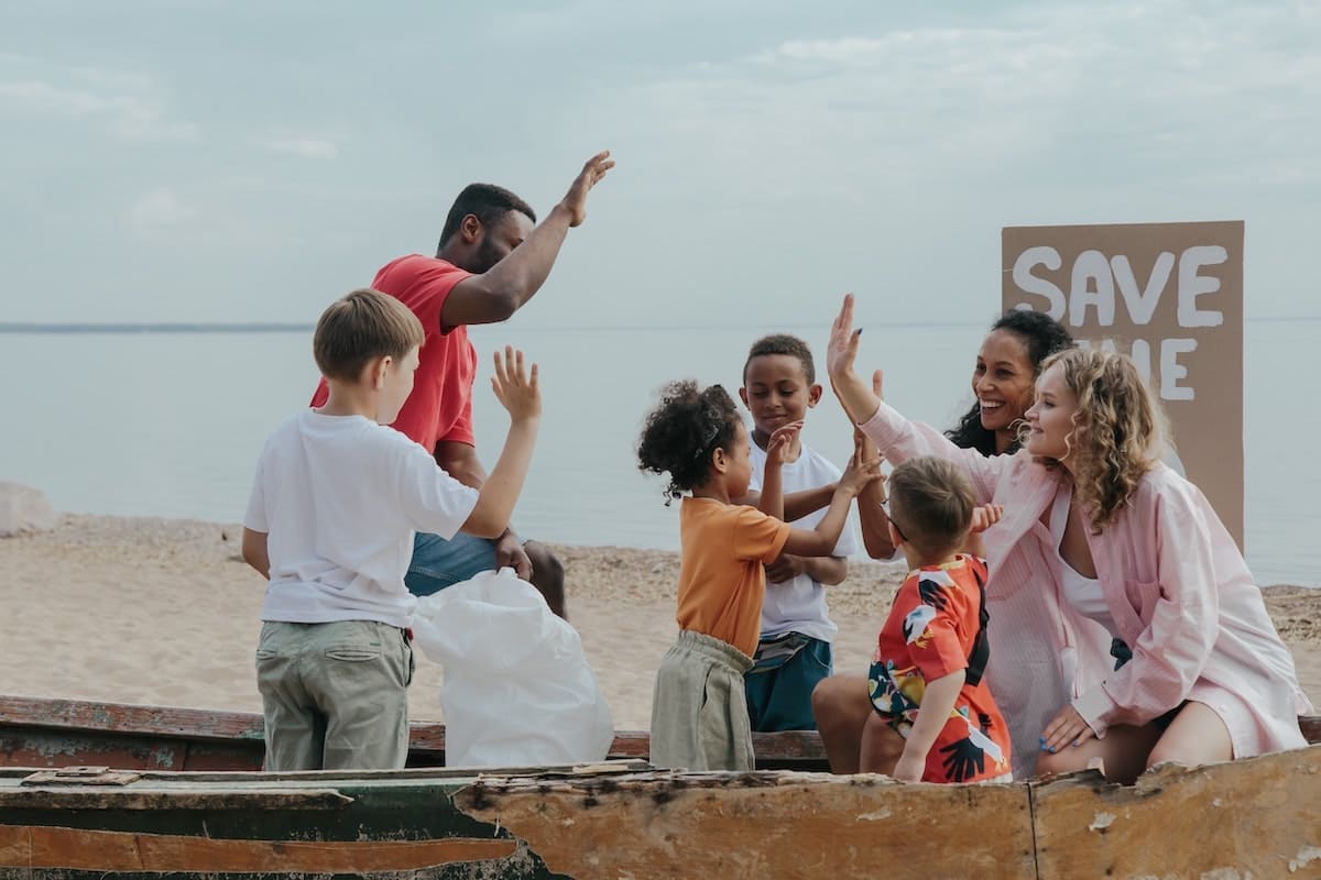 Adults and children giving each other high-fives as part of their personal mission statement.