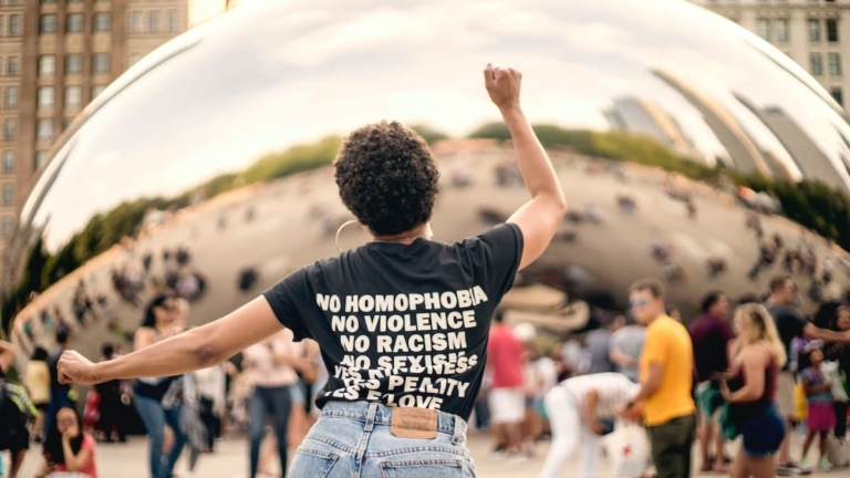 Woman dancing with her personal mission statement written on the back of her t-shirt.