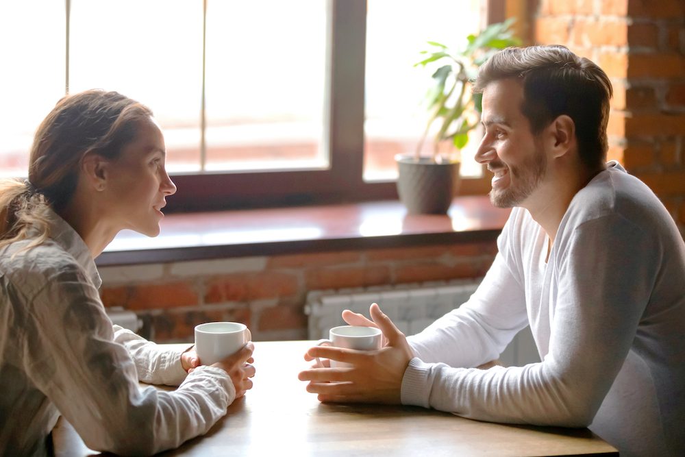 Couple communicating over coffee