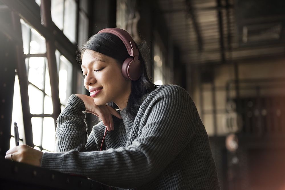 Asian Woman Listening Music Headphone Writing Notebook Concept