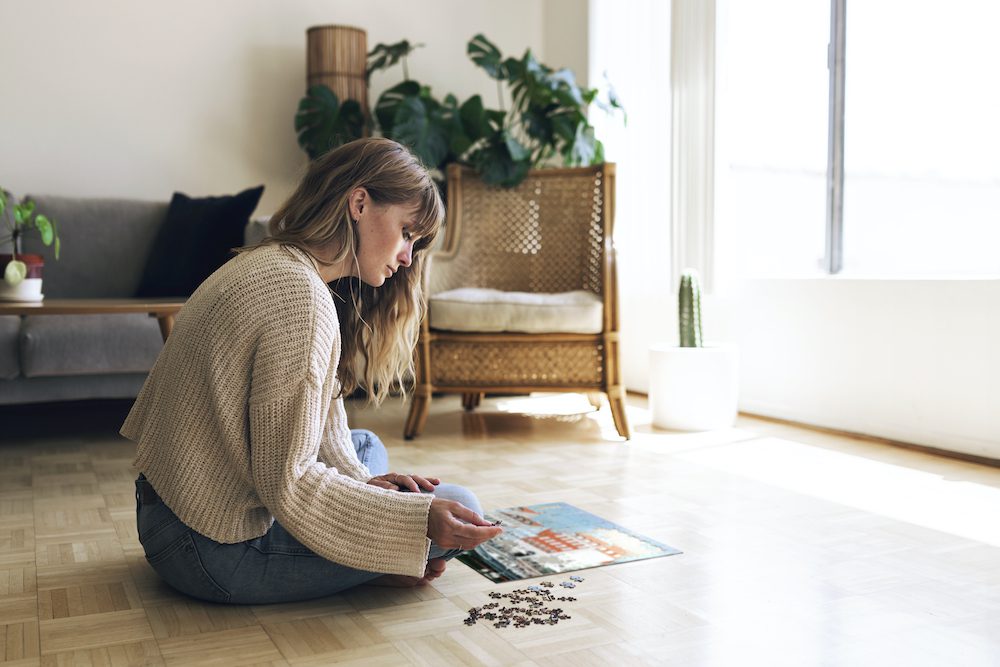 Woman assembling a jigsaw puzzle to gain self control