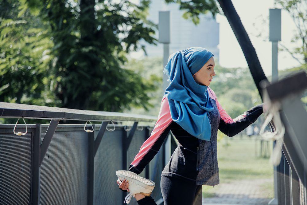 Woman in hijab using exercise to overcome depression naturally