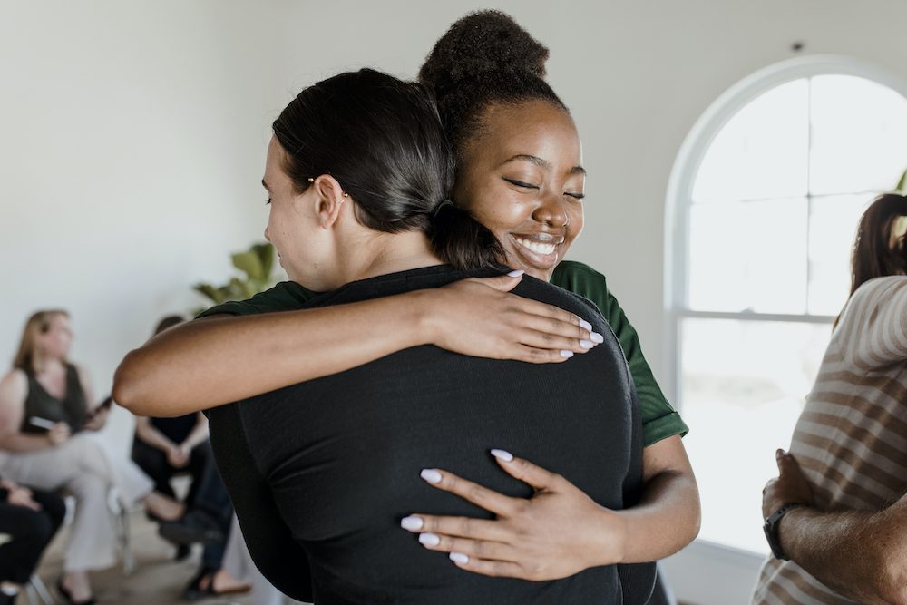 Women hugging each other