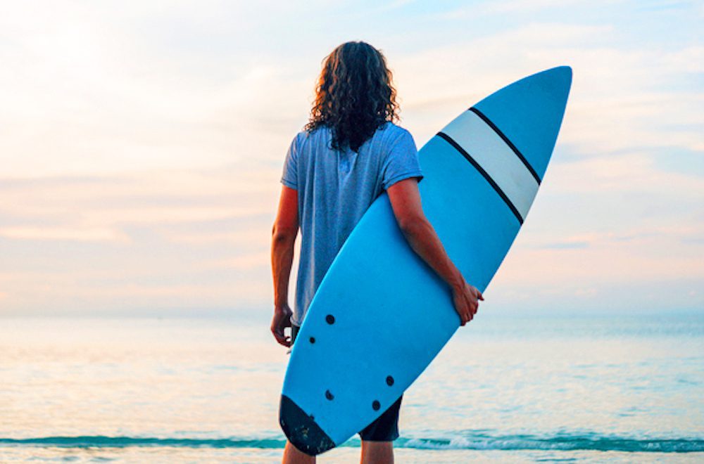 Surfer On Beach In Sunrise