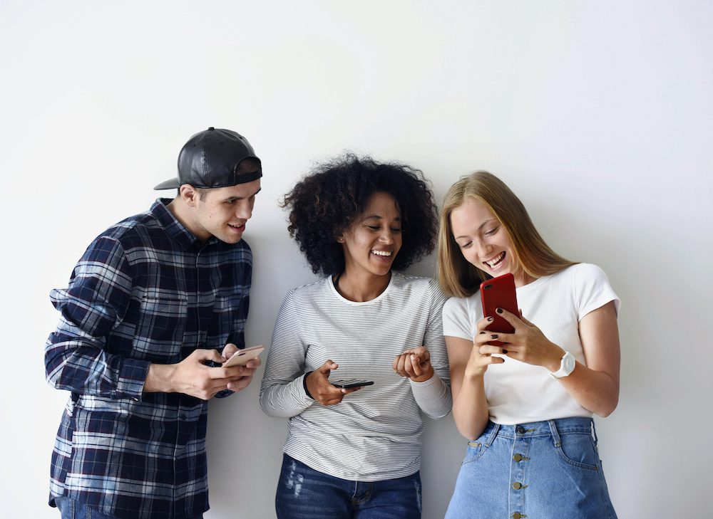 Young friends checking their phones