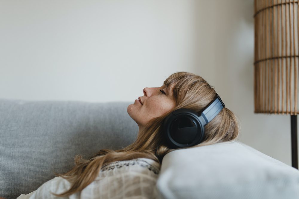 Woman listening to sound waves for healing