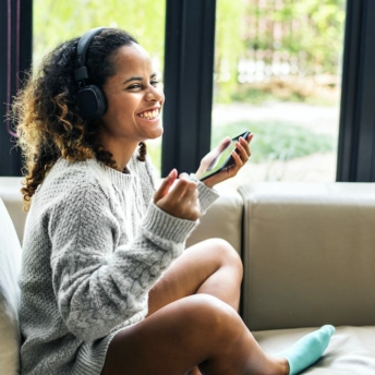 Woman enjoying music on her sofa