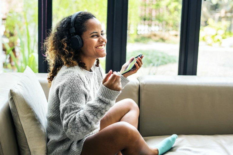 Woman enjoying music on her sofa