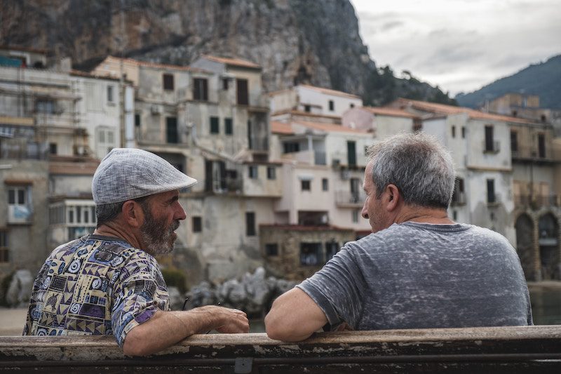 two old men sitting on a bench