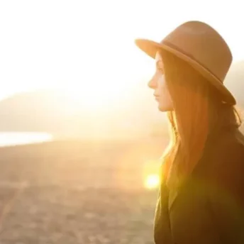 Woman on the beach enjoying the sun