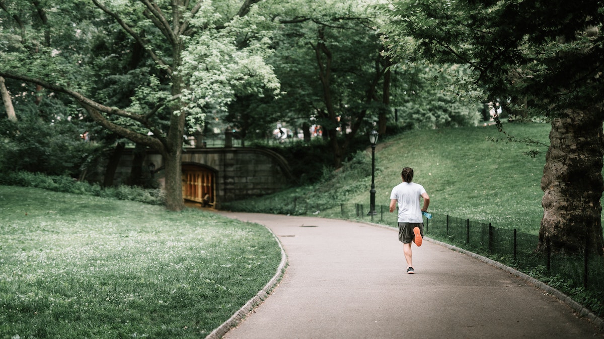 Man running as part of a weight loss exercise habit