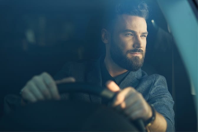 man driving a car