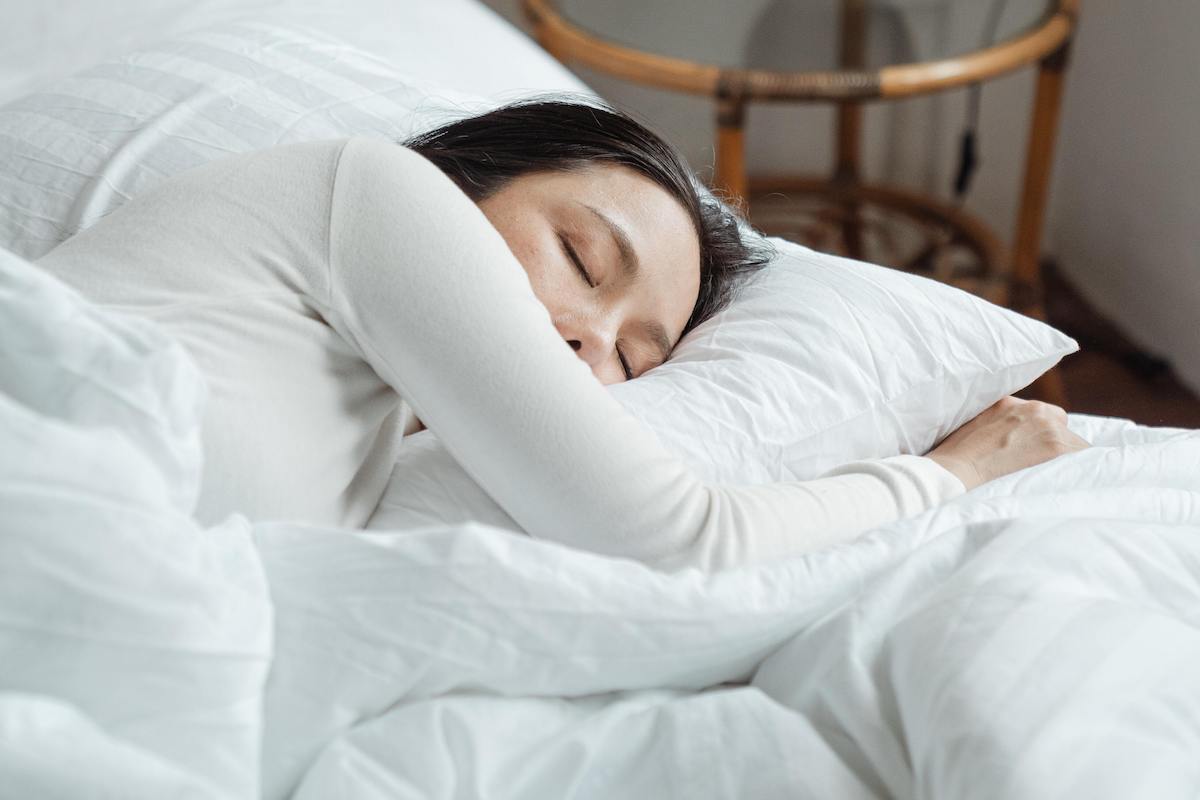 Woman taking a nap to learn how to fix sleep schedule.