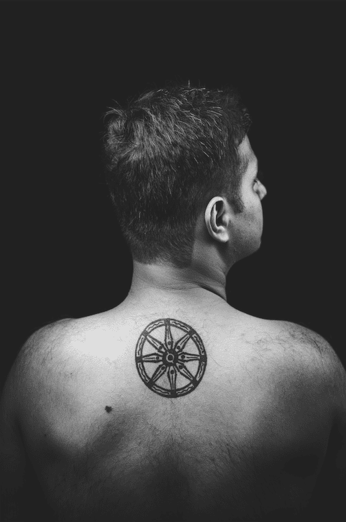 Premium Photo | Rear view of woman with tattoo on back against white  background