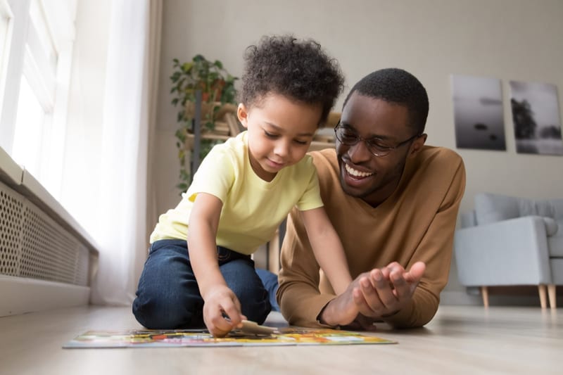 Father and child doing puzzles