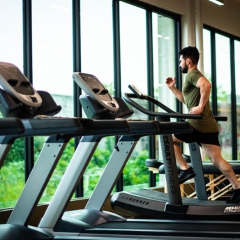 Man running on a treadmill showing how to lose weight in a month