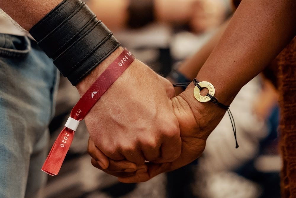 Participants holding hands at a Mindvalley event