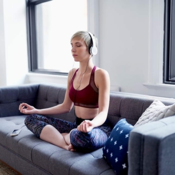 Woman meditating with headphones on