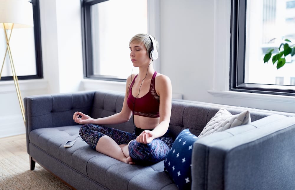 Woman meditating with headphones on