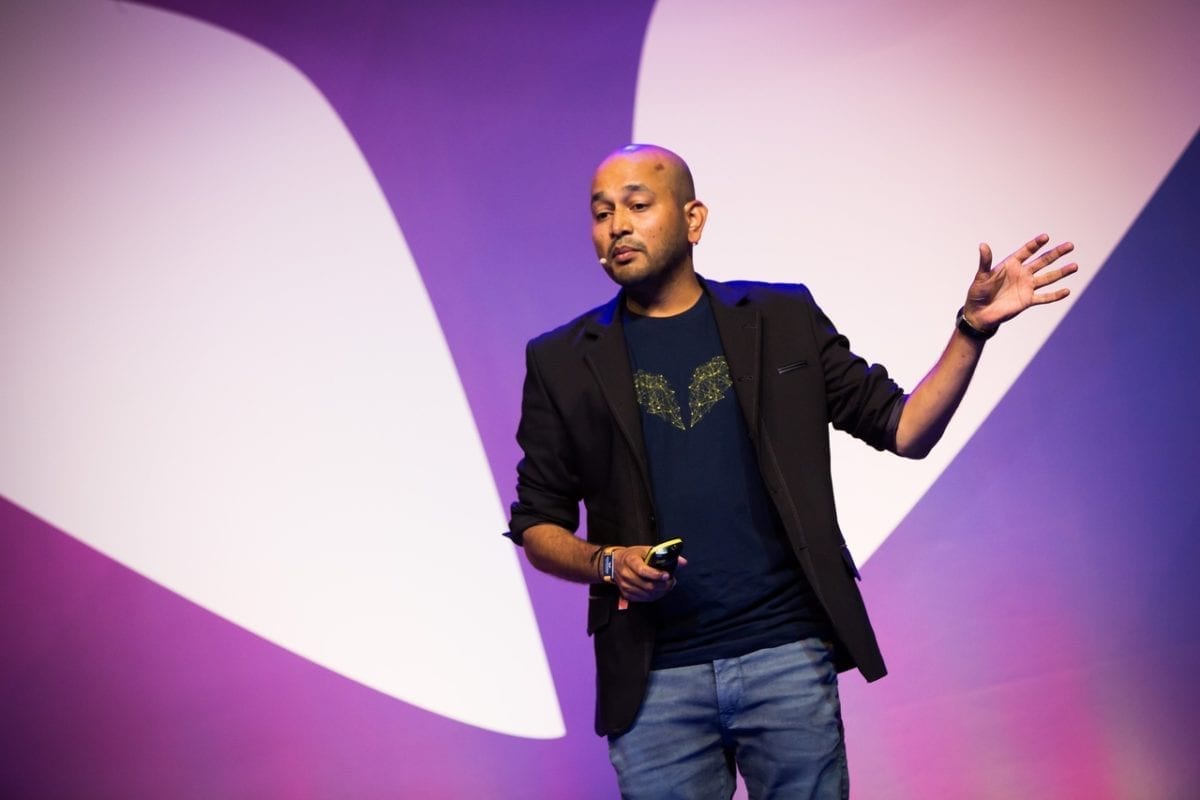 Ajit speaking on stage at Mindvalley University 2018