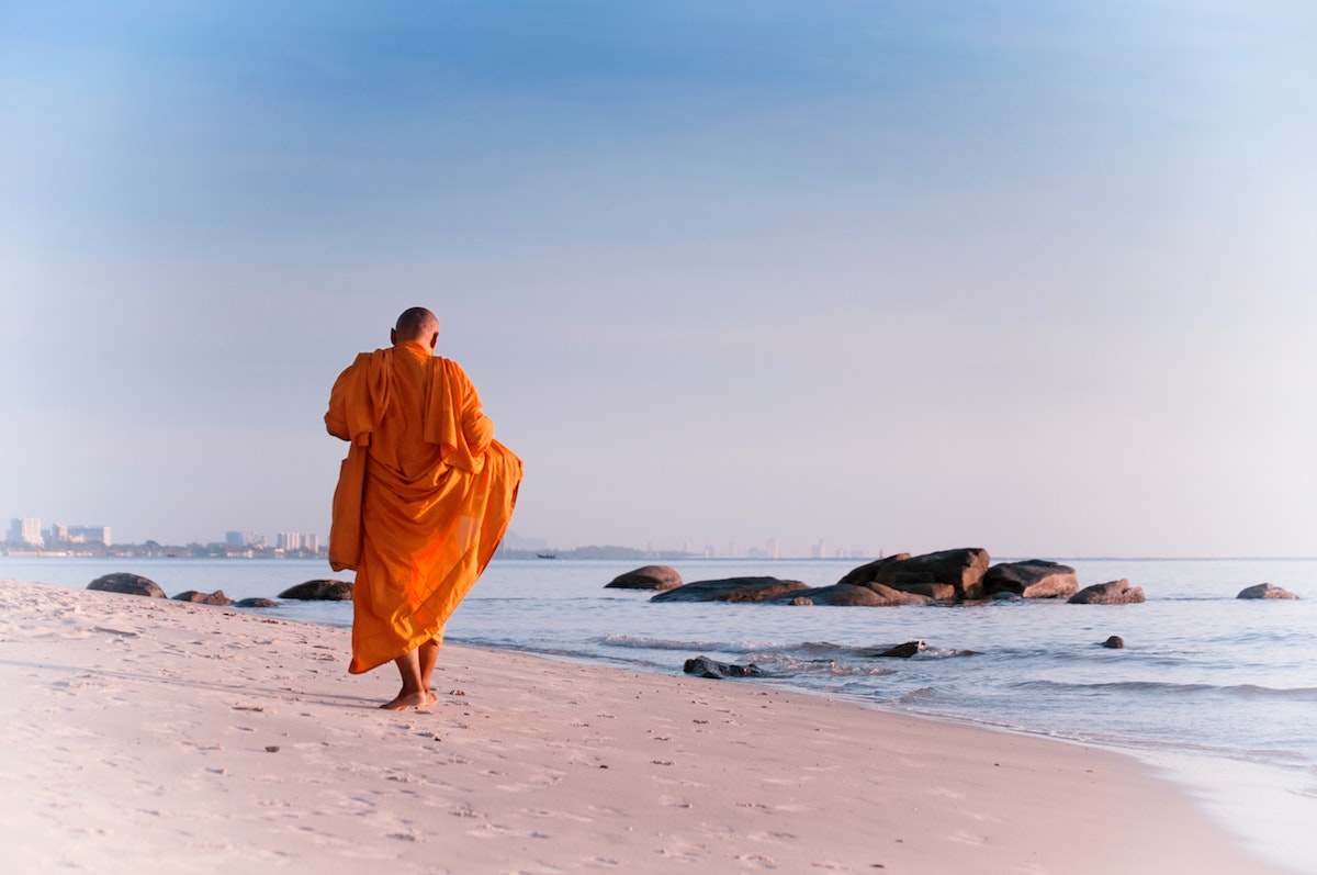 monk walking on the beach