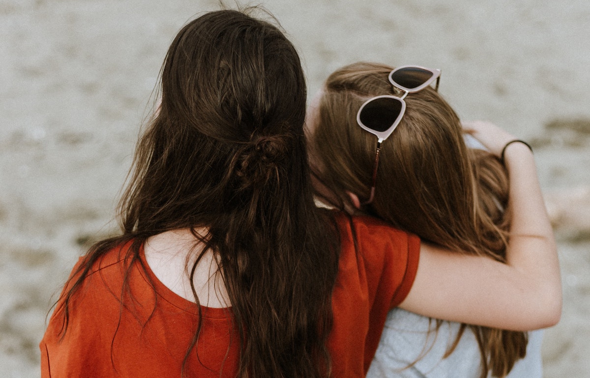 two girls hugging each other